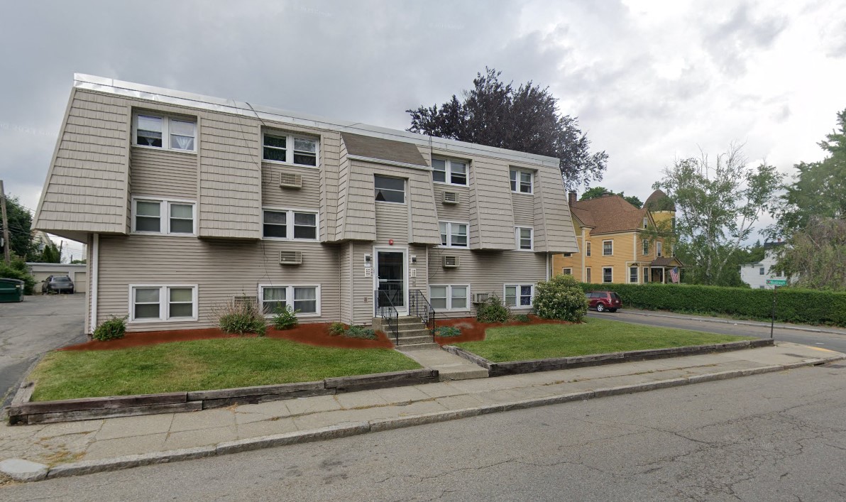 an apartment building on the corner of a street
